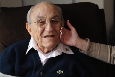 Volunteer showing older man care