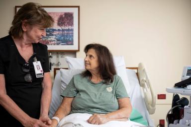 Woman nurse sitting with a woman patient 