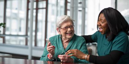 Rehabilitation Center listens to therapeutic music with the help of a life enhancement team member.