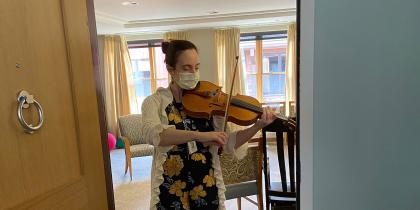 NewBridge on the Charles employee, Leticia Alvaraz, plays a violin while wearing a face mask during the COVID-19 coronavirus pandemic