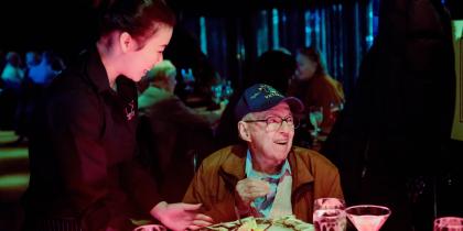 A senior receives his wish of having a martini party through the Power a Dream program