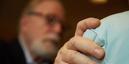 Rabbi Joel Barron comforts someone who is receiving hospice care