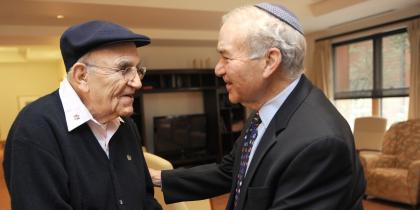 Two men shake each other's hands