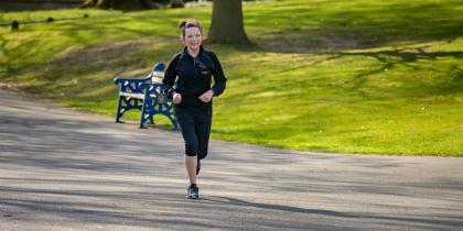 Woman in black jacket jogging