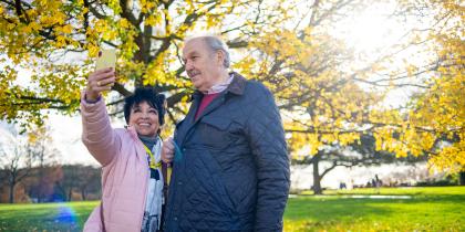 senior couple outside taking a photo