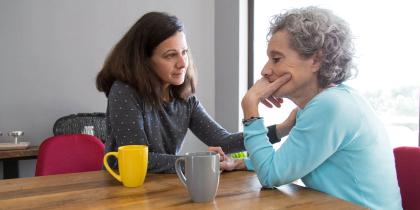 Adult woman sitting with older mother
