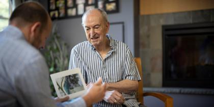 Older man sitting with younger man