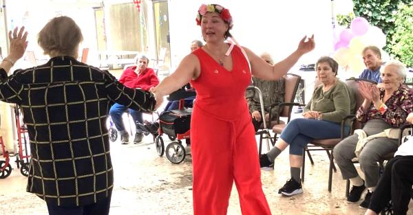 Iana dancing with a resident