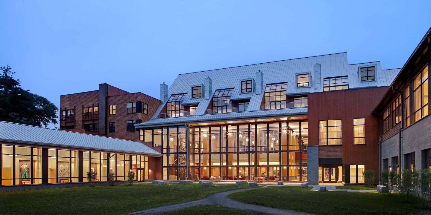 The Shapiro Community Center at NewBridge on the Charles, pictured at dusk, offers many amenities open to all NewBridge residents.