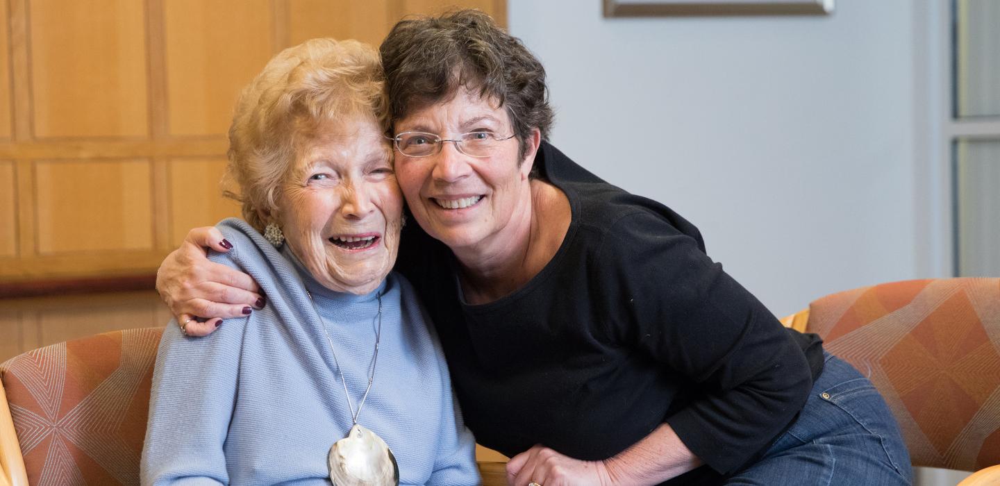 Young woman hugging older woman