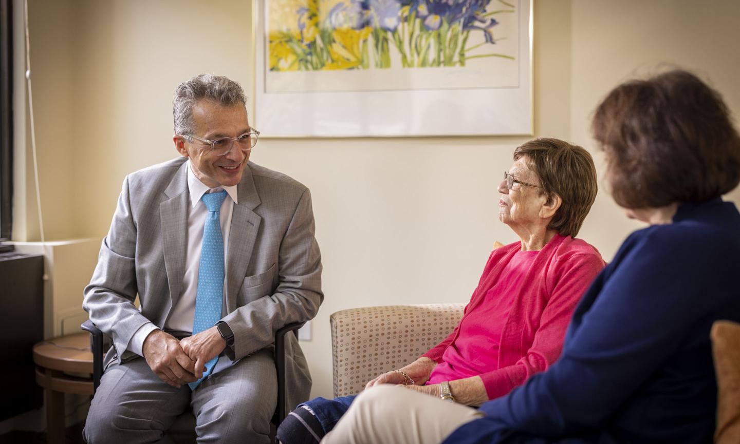 Dr. Alvaro Pascual-Leone of Hebrew SeniorLife’s Wolk Center for Memory Health in Boston speaks with a patient and the patient’s daughter.