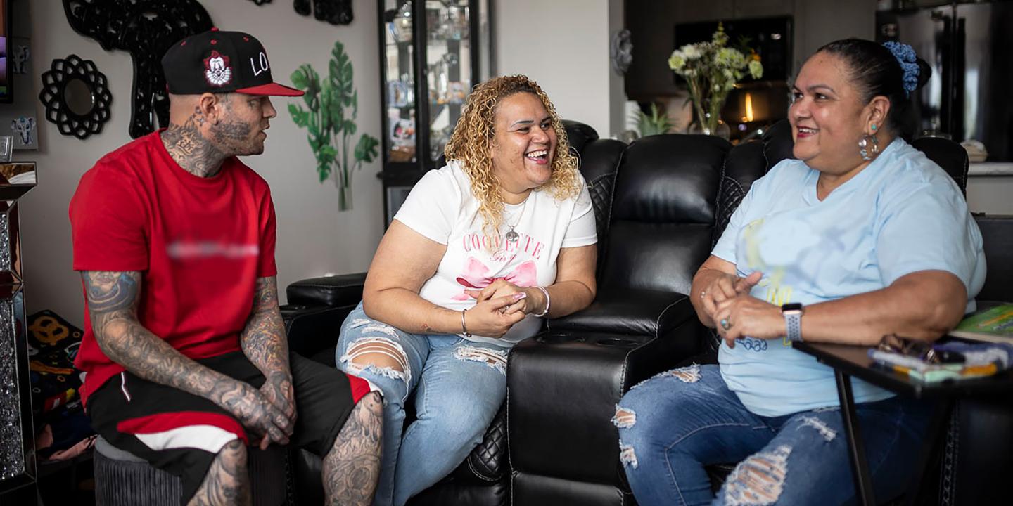 People sitting on a couch in an apartment