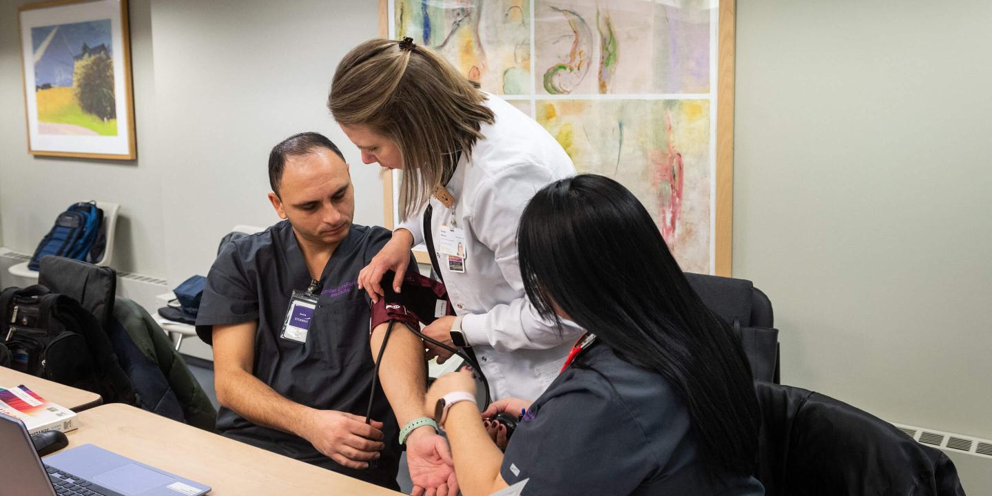 Nursing students practicing in a classroom