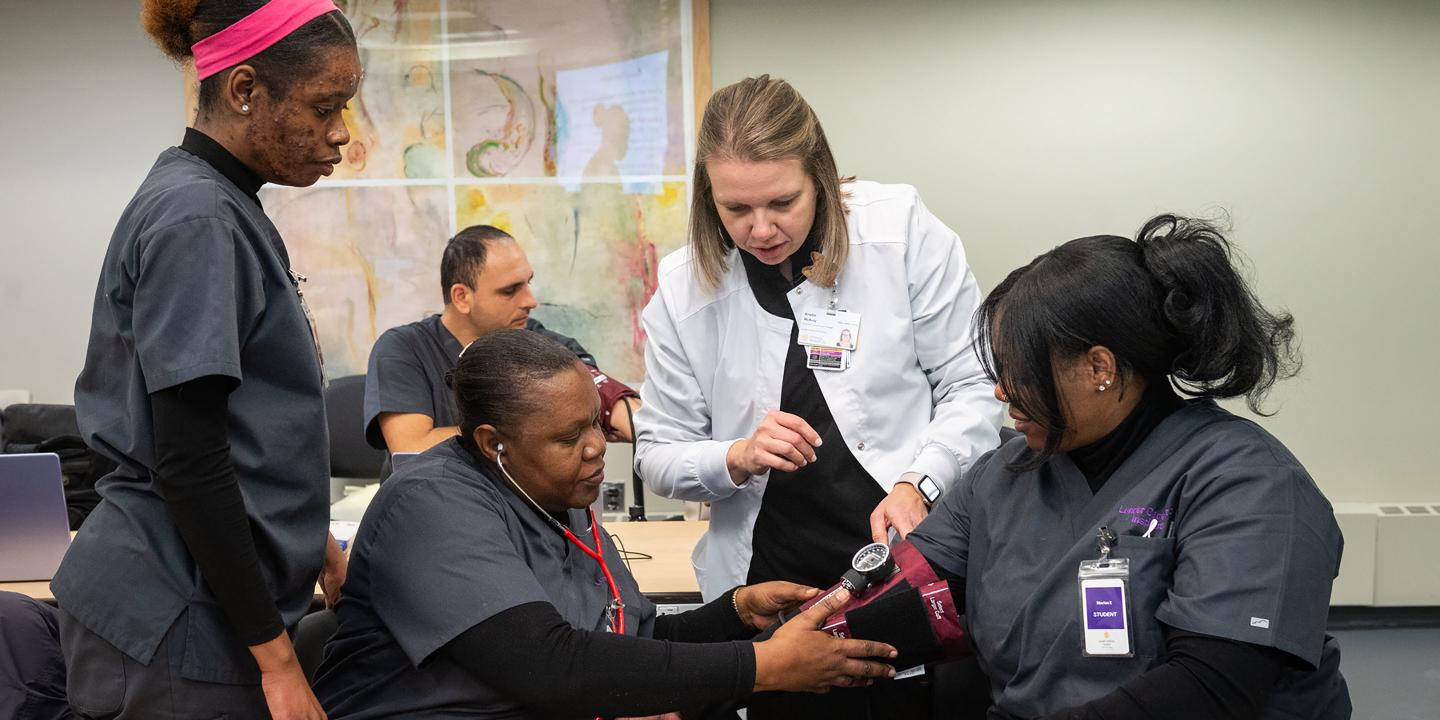 CareForce students practicing using a blood pressure monitor