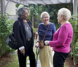 Three CCB residents enjoy a moment in the outside garden.