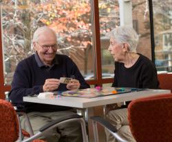 Two CCB residents enjoy a game of Trivial Pursuit