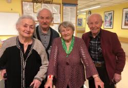 Four Russian-speaking patients smile for the camera as they enjoy the Shatlmans Soybelis event.