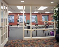 The entrance to the Center Communities of Brookline fitness room, lined with fitness equipment.