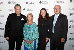 Attendees of HSL’s EngAGE fundraising event standing with Lou Woolf