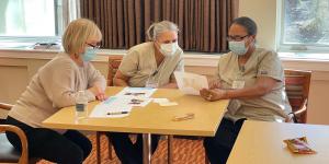 Three women nurses reviewing paperwork