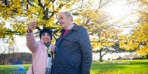 senior couple outside taking a photo