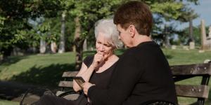 woman sitting with grieving friend