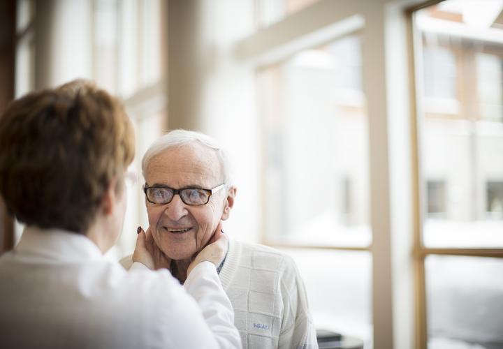 An older man is seen by a Harvard Medical School-affiliated health care provider as part of the on-site health care services offered at NewBridge on the Charles.