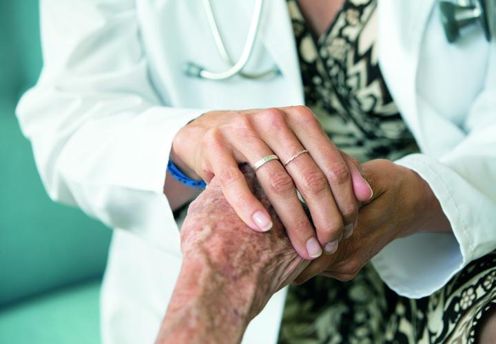 Close up of the hand of an Orchard Cove geriatrician as she counsels a patient.