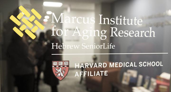 Glass window with white logo on it saying Marcus Institute for Aging Research.
