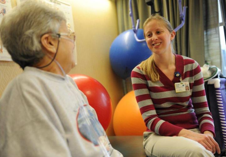 A patient meets with a therapist during a rehabilitation session with staff at Hebrew Rehabilitation Center. 