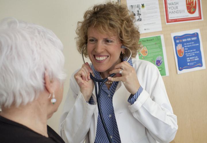 A resident of Center Communities of Brookline sees a Hebrew SeniorLife geriatrician at the medical practice in her building.