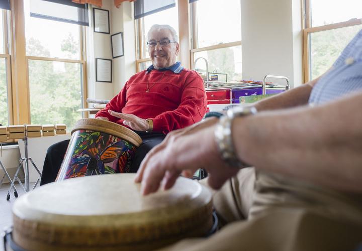 Older adults participate in a drum circle