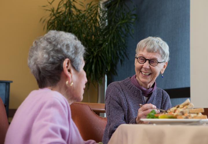 Two Center Communities of Brookline women eating and laughing together 