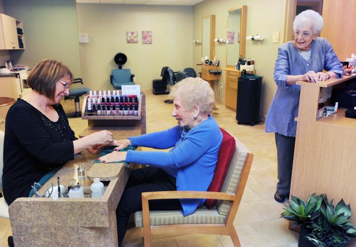 Two assisted living residents of NewBridge the Charles enjoy full-service salon treatments at our beauty salon.
