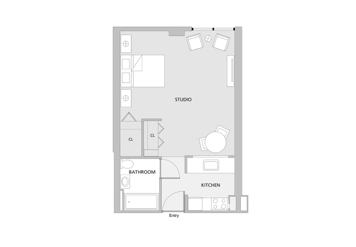 Floorplan of a rectangular shaped apartment with one main open room with a bed, small table, and two chairs connected to a small galley kitchen and small bathroom.