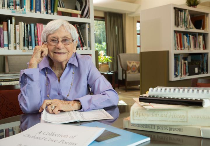 Older woman works on a creative writing project in the Orchard Cove library.