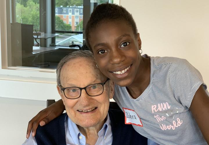 A school-age girl and a senior living resident enjoy their time participating in an intergenerational program.