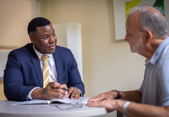 Dr. Caleb Jordan speaks with a patient at the Wolk Center for Memory Health.