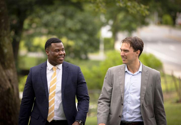 Dr. Caleb Jordan and Dr. Davide Cappon have a discussion while walking outside.