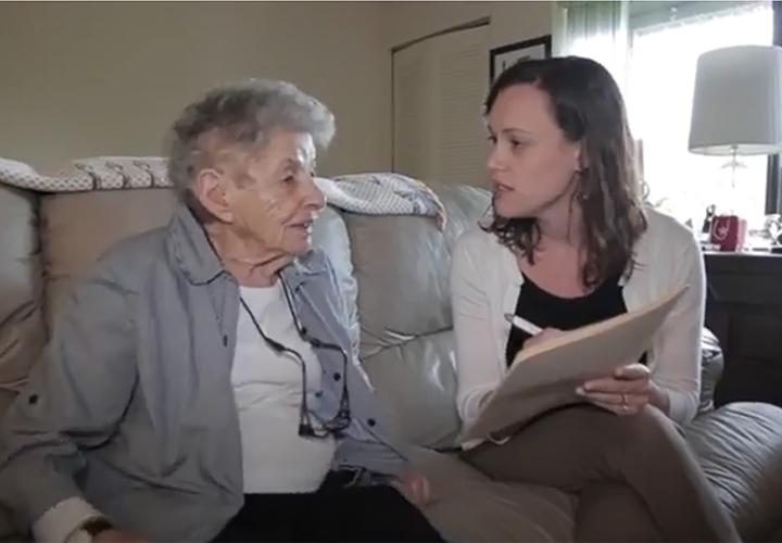 Woman wellness coach sitting with woman resident