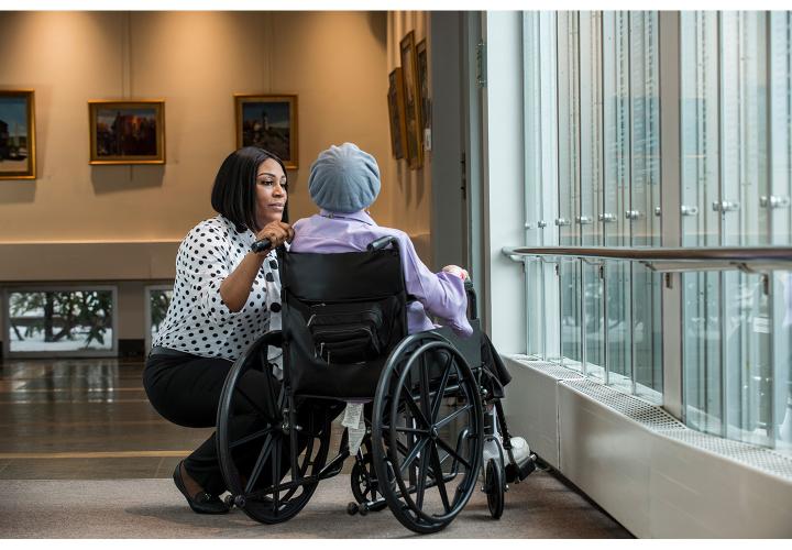 woman sitting with elder in chair