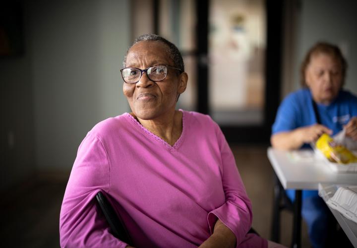 Woman sitting at Leyland Community smiling