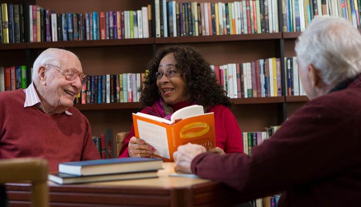 Group of older people sitting together in a library