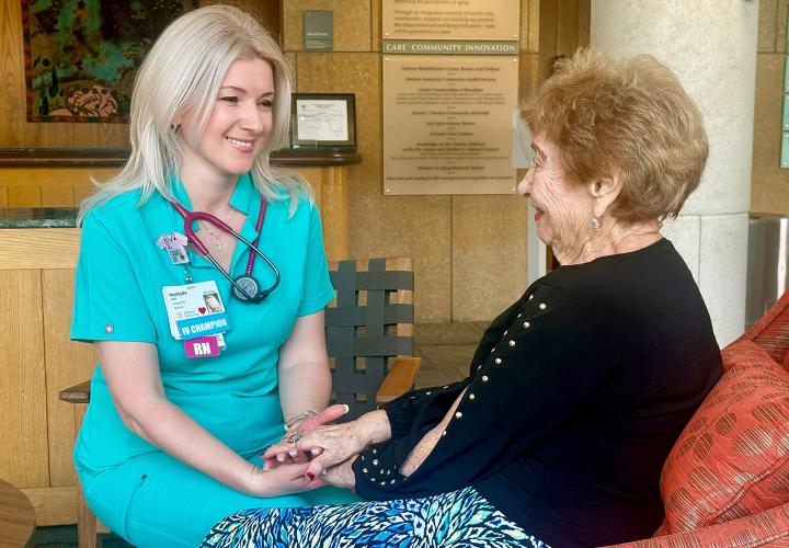Nurse sitting with patient