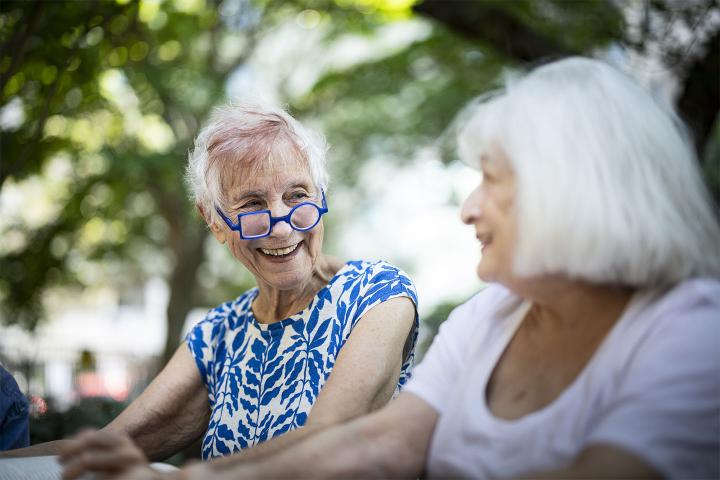 Two older women sitting outside