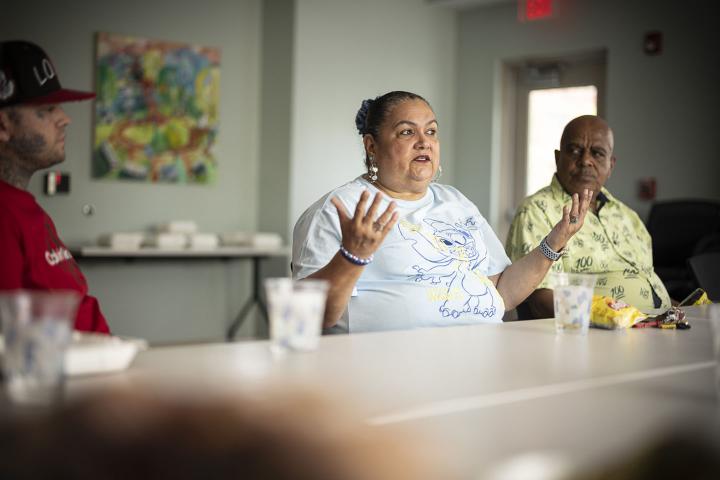 A Hispanic woman participates in a discussion group at Leyland Community.